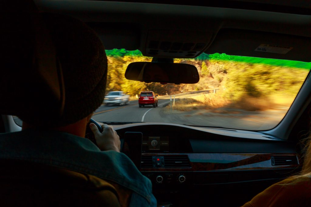 photo from backseat of a driver on a windy road